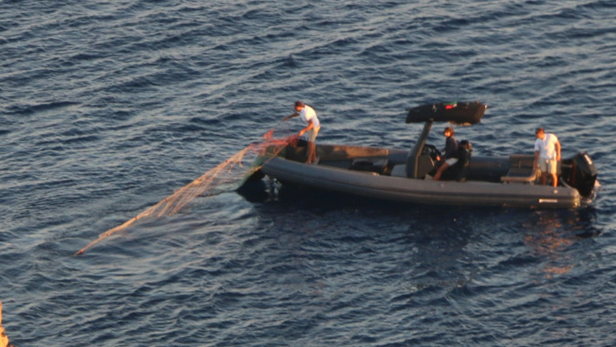 Una foto, scattata dai volontari di Legambiente, dei pescatori di frodo Una foto, scattata dai volontari di Legambiente, dei pescatori di frodo