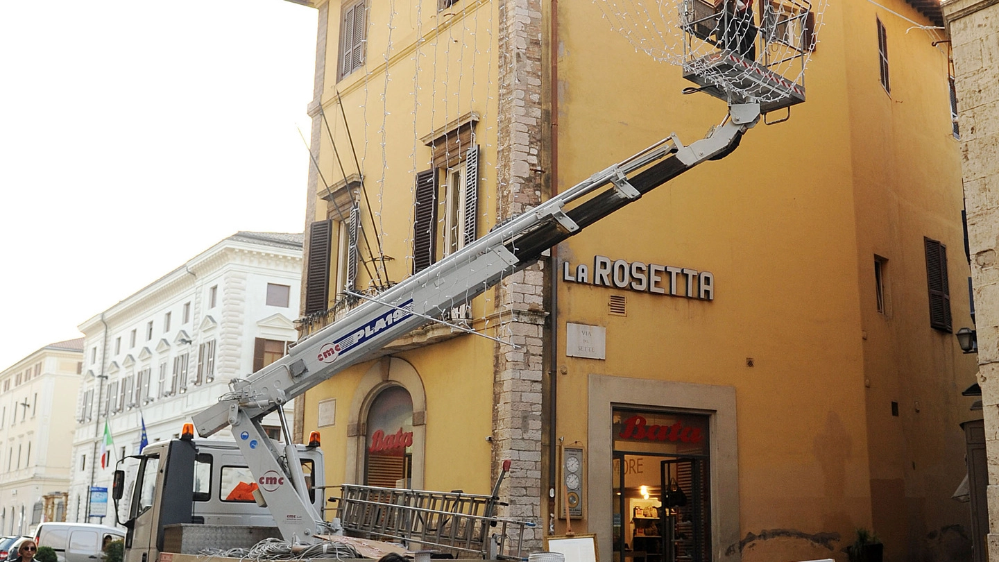 PREPARATIVI Tecnici e operai alla prese con il montaggio delle luminarie natalizie nel centro di Perugia