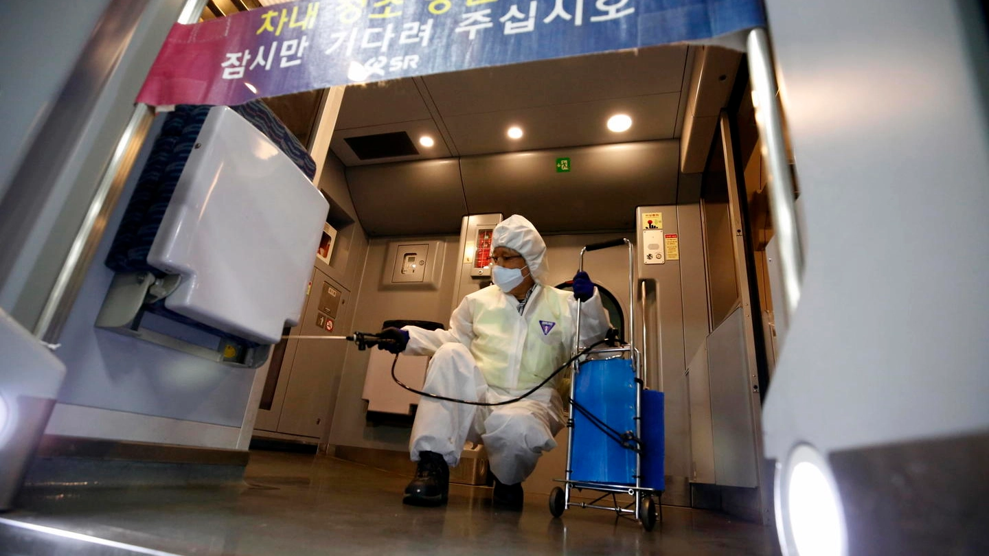 Coronavirus, disinfestazione di un treno a Seul (Ansa)