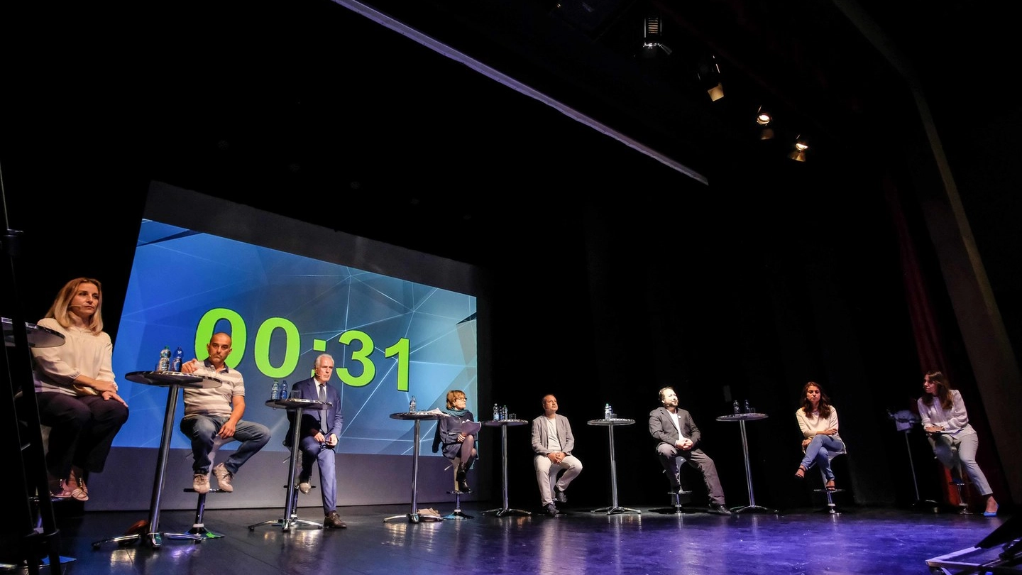 Il confronto fra candidati al Teatro Puccini (foto Giuseppe Cabras/New Press Photo)