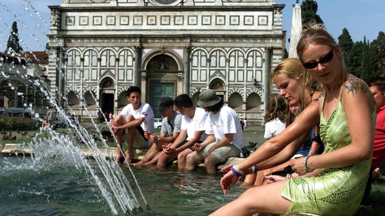 Turisti si bagnano nelle fontane della città per sfuggire al caldo africano degli ultimi giorni