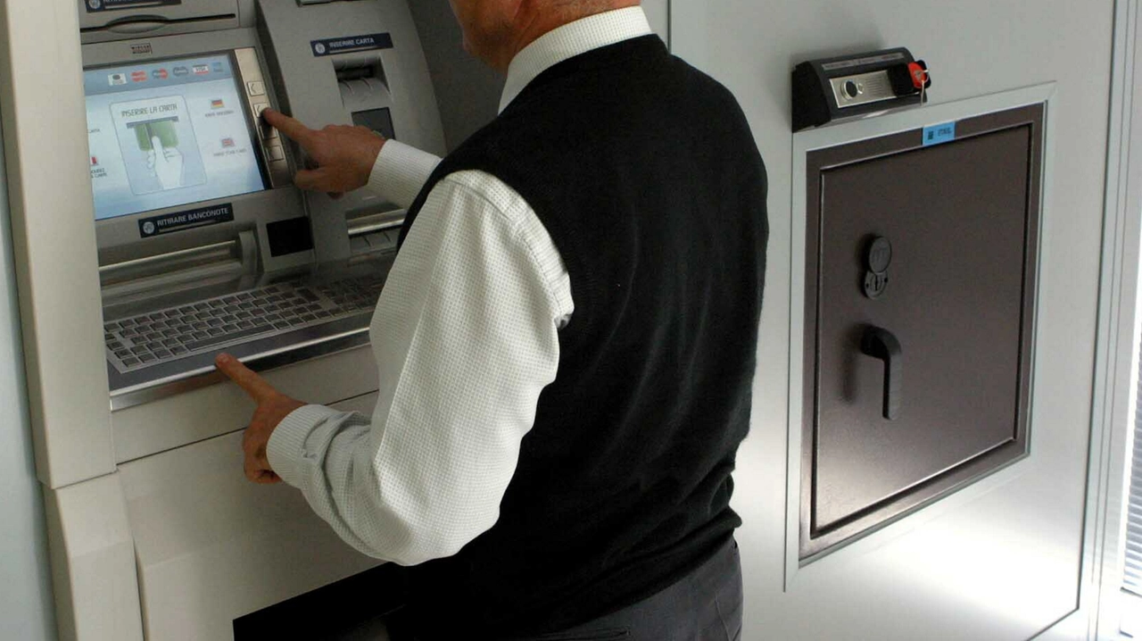 Un uomo ritira contanti da un bancomat (foto di repertorio) Un uomo ritira contanti da un bancomat (foto di repertorio)