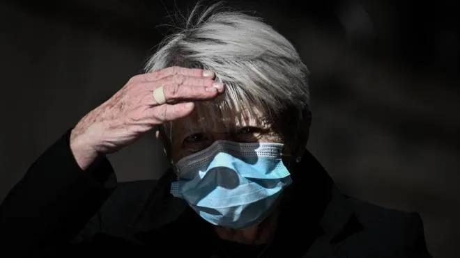 A woman wearing a protective face mask walks in a street of Bordeaux on October 28, 2020 as France is set to put tough new measures in place. - Frennch President Emmanuel Macron is set to announce tough new restrictions on October 28 to halt a flare-up in Covid-19 cases, with a month-long national lockdown mooted as hospitals battle an influx of patients. Macron will deliver a televised address to the nation at 8:00 pm (2000 GMT), a day after officials announced 523 coronavirus deaths in 24 hours -- the highest daily toll since April. (Photo by Philippe LOPEZ / AFP)