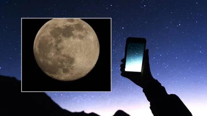A hand is holding smartphone with starry sky photo: a man is taking a photo starry sky at night. Milky way and galaxy on dark sky. Wifi mobile internet concept (A hand is holding smartphone with starry sky photo: a man is taking a photo starry sky at
