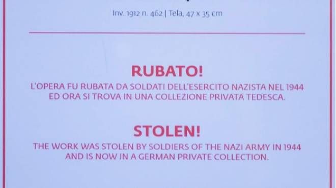 Il cartello apposto agli Uffizi sulla copia del quadro